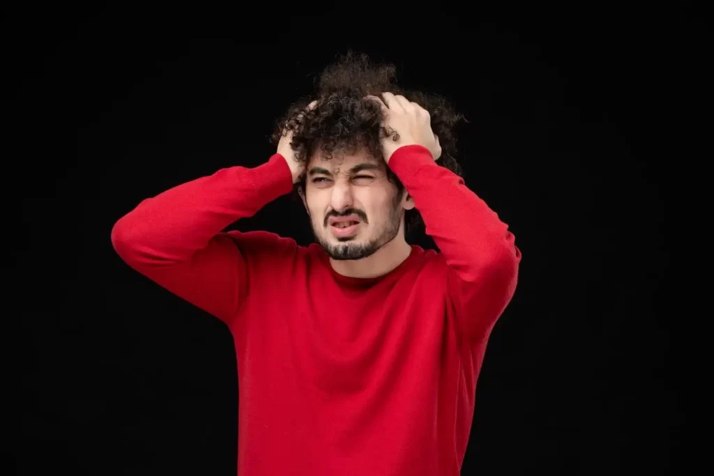 A man showing signs of stress, reflecting emotional strain often explored in therapy.